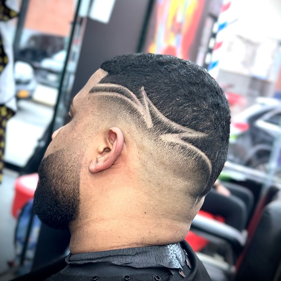 Custom hair design art shaved into a fade at Authentic Cutz