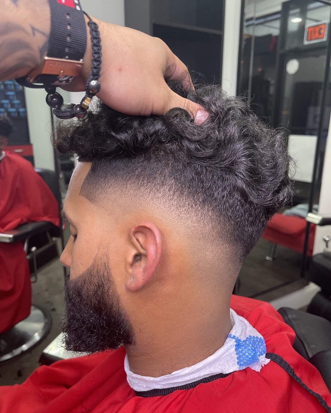 Curly top with clean fade at Authentic Cutz Barbershop Bronx NY