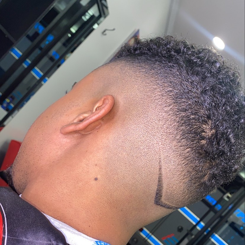 Skin fade with shaved design detail at Authentic Cutz